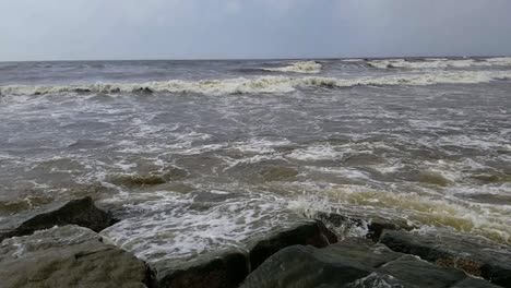 Waves-from-the-Gulf-of-Mexico-crashing-into-the-rocks-in-Galveston-Texas