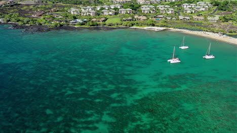 Drone-footage-of-3-sailboats,-in-a-bay,-off-the-Big-Island-of-Hawaii