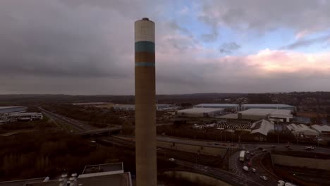 Aerial-footage-of-the-Stoke-on-Trent-incinerator-recycling-centre-in-the-midlands-Staffordshire,-garbage,-refuse,-waste-incineration-plant-with-smoking-smokestack-creating-more-industrial-pollution