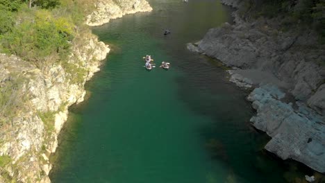 SLOWMO---People-on-canoe-tour-paddle-beautiful-pristine-clear-blue-Pelorus-River,-New-Zealand---Aerial-Drone