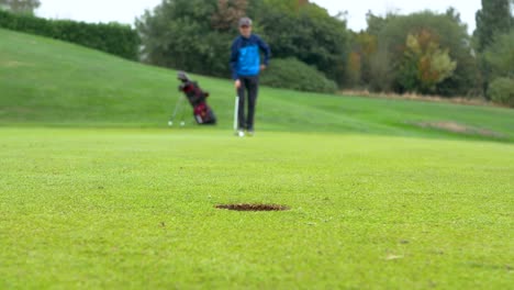 Blurred-out-golfer-going-through-his-putting-routine-with-focus-on-the-hole
