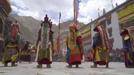 Lamas-wearing-colorful-dresses-and-masks-dance-at-Hemis-festival-in-monastery-on-sunny-day-with-clouds