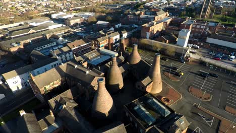 Aerial-view-of-the-famous-bottle-kilns-of-Gladstone-Pottery-Museum,-formerly-used-in-manufacturing-in-the-city-Stoke-on-Trent,-Staffordshire,-industrial-decline,-poverty-and-cultural-demise