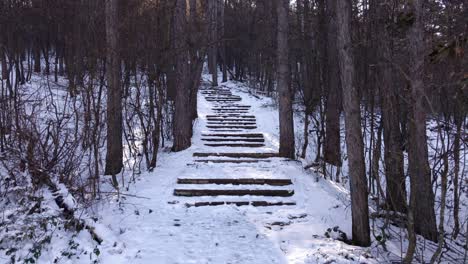 Inspiring-revealing-shot-of-snowy-stairs-in-the-mountain-during-the-winter