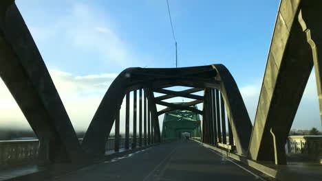 Driving-and-crossing-an-old-historic-landmark-bridge-in-Reedsport,-Oregon,-on-Highway-101,-United-States