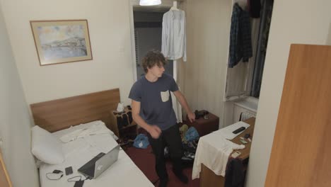 Young-man-dancing-in-dorm-room