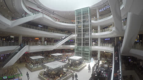Nonthaburi-Thailand---Circa-Time-lapse-of-crowds-moving-through-multiple-floors-of-a-shopping-mall-using-escalators,-glass-elevators-and-walking