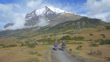 Group-of-hikers-hiking-towards-Paine-Towers-in-Torres-Del-Paine-National-Park,-Patagonia,-Chile