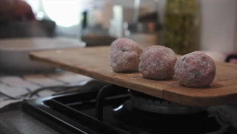 Housewife-making-delicious-meatballs-on-kitchen-counter-top