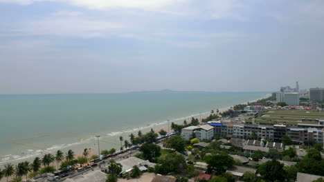 Pattaya-Thailand-City-Beach-Timelapse-on-Cloudy-Day-with-Traffic-on-Road-Buildings-and-Gulf-Sea-Water-with-Boats