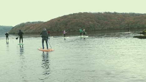 Crowd-of-people-stand-up-paddle-board-on-lake-scenic-views