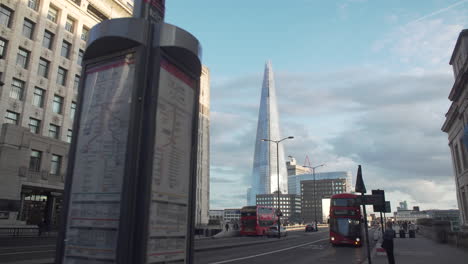 Bus-traffic-in-front-of-The-Shard-building-in-London,-England