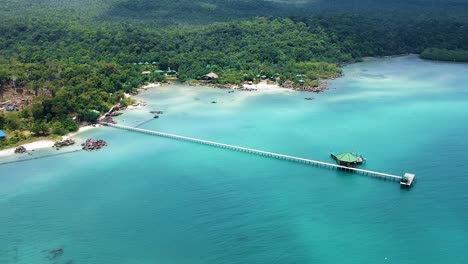 Aerial-landscape-of-beach-resort-with-long-pier-and-turquoise-blue-sea