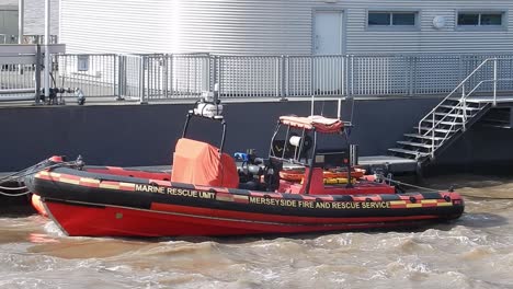 Liverpool's-marine-rescue-unit-boat-on-choppy-coastal-waters,-moored-outside-offices-on-docks
