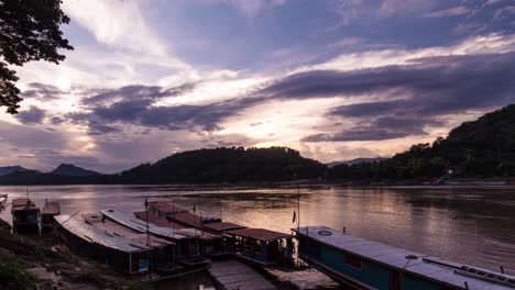 Tourist-boats-parked-on-the-Mekong-in-South-east-Asia-with-the-setting-sun-and-clouds