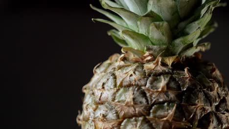 Isolated-pineapple-fruit-on-black-background-rotating-through-the-screen