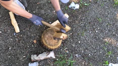 Unrecognizable-man-splitting-the-wood-with-an-ax