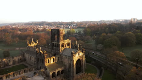 Aerial-Pan-of-Kirkstall-Abbey-at-Dawn-on-Sunny-Spring-Day-with-Birds-Flying-Around