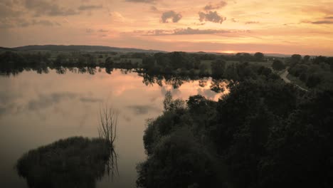 Drone-Aerial-Shot-of-a-quite-Lake-at-Sunset-in-Germany
