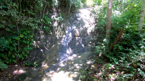Eine-Langsam-Nach-Oben-Schwenkende-Aufnahme-Eines-Kleinen,-Plätschernden-Wasserfalls-Im-üppigen-Tropischen-Dschungel-Der-Philippinen