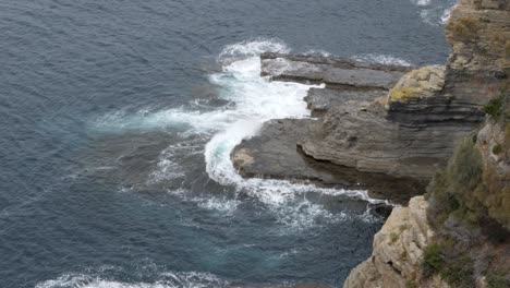 Slow-Motion-Of-Ocean-Waves-Crashing-Over-Rock-Face,-Tasmania,-Australia