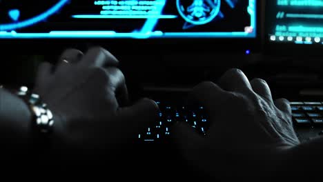 Close-up-of-the-hands-of-a-hacker-cyber-criminal,-typing-rapidly-on-a-keyboard