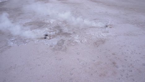 El-Tatio-geysers-steaming-from-the-ground-in-the-Atacama-desert-in-Chile,-South-America