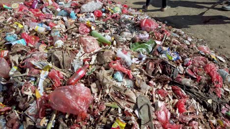 Closeup-plastic-bottles-and-bags-piled-up-on-road,-urban-garbage-problem