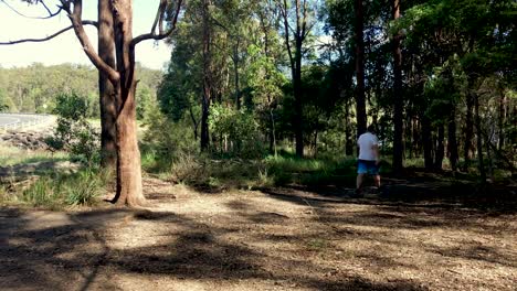 Bushwalking-man-walks-past-panning-camera-in-the-Australian-Bush