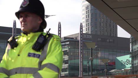 A-police-officer-stands-guard-in-front-of-British-Broadcast-Corporation-offices-at-Media-City-UK-in-Salford-during-a-far-right-protest-against-“fake-news”
