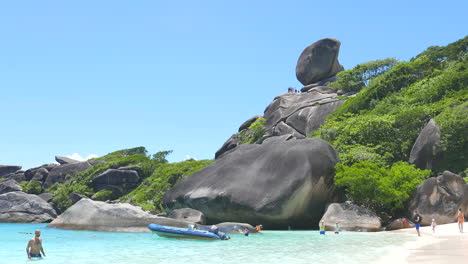 Phuket-Thailand---Circa-View-of-the-giant-greenery-covered-rocks-on-the-white-sand-beach-at-Similan-Island-National-Park-in-Thailand-with-tourists-and-a-boat