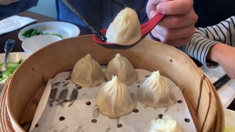 A-video-tutorial-on-how-to-eat-traditional-soup-dumplings-at-a-Chinese-restaurant