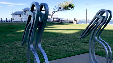 Pelican-Sculptures-with-Woody-Point-Jetty-in-background-on-a-cold-sunny-morning