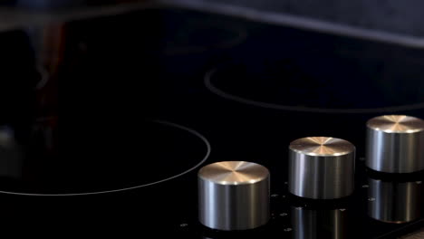 A-electric-stove-or-hob-being-turned-on-by-a-knob