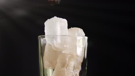 A-showcase-of-the-rotation-cola-with-ice-close-up-for-a-very-large-glass-of-cold-with-slow-motion-rotating