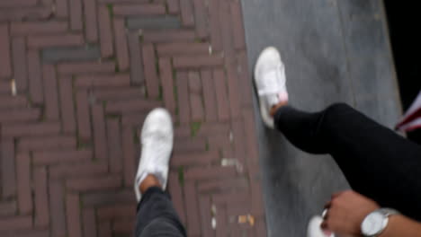 A-couple-with-white-shoes-walk-through-the-streets