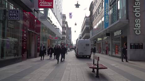 POV-walking-down-Drottninggatan-shopping-street-in-Stockholm,-slow-motion