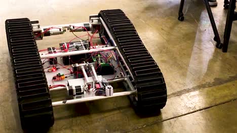 Engineering-project,-student-work-in-the-lab-to-build-and-test---robotic-rover-moving-forward,-backward-and-turning