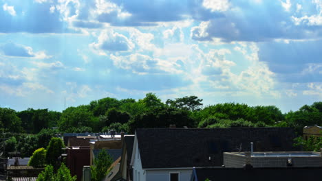 Time-lapse-of-urban-neighborhood-with-rolling-clouds-daytime-to-darkness