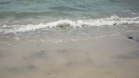 Close-up-movement-of-the-sea-waves-on-the-white-sand-beach