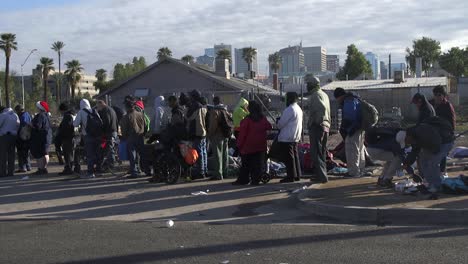 A-long-line-of-homeless-men-and-women-wait-to-get-essentials-for-survival-on-the-streets,-Phoenix,-Arizona