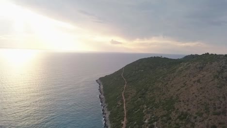 Albanian-Riviera-at-sunset-with-the-sun-rays-piercing-through-the-clouds-to-light-up-the-Adriatic-Sea