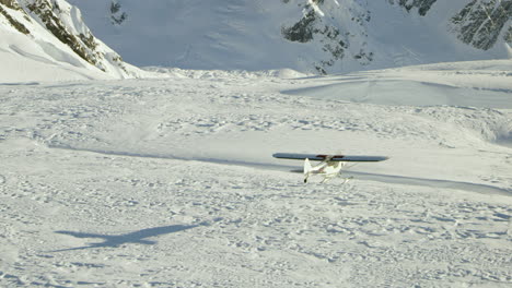 Airplane-flies-low-over-deep-snow-covered-crevasse