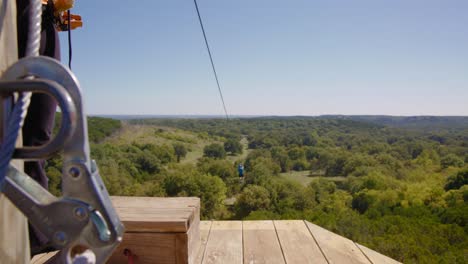 A-young-man-glides-out-across-the-Oklahoma-treetops-on-a-zip-line