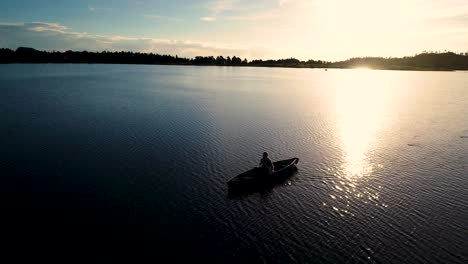 Beautiful-Colorado-sunrise-on-a-lake-with-a-silhouette-of-a-canoe-against-the-rising-sun