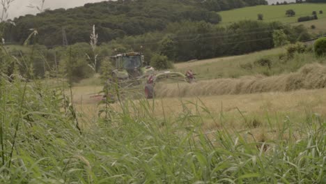 Tractor-pulling-hay-raker-in-field