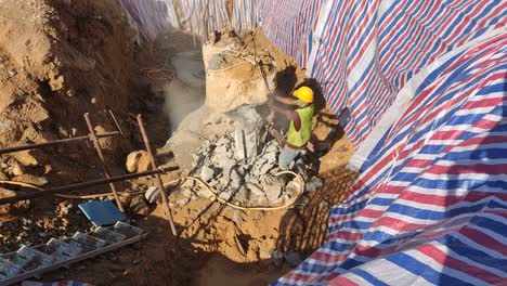 A-construction-worker-cutting-and-breaking-foundation-bore-pile-using-a-hacking-method-at-the-construction-site