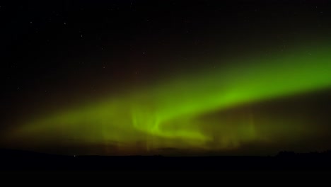 Vivid-green-aurora-borealis-spreads-across-the-prairie-night-sky