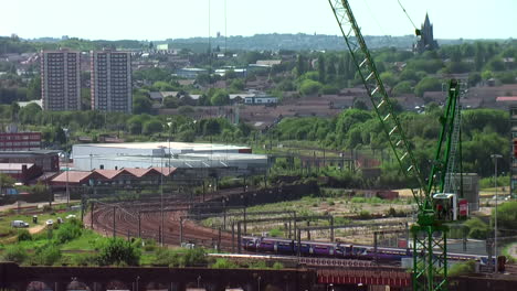 Time-Lapse-of-Various-Trains-Approaching-Leeds-City-Centre-Station-on-an-S-Bend-of-Track-during-a-Bright-Summer’s-Day-with-Moving-Crane-in-Foreground