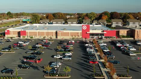 Wide-angle-aerial-push-in,-Target-discount-retailer-store-located-in-suburbs-beside-busy-highway-and-housing-mixed-use-development-project